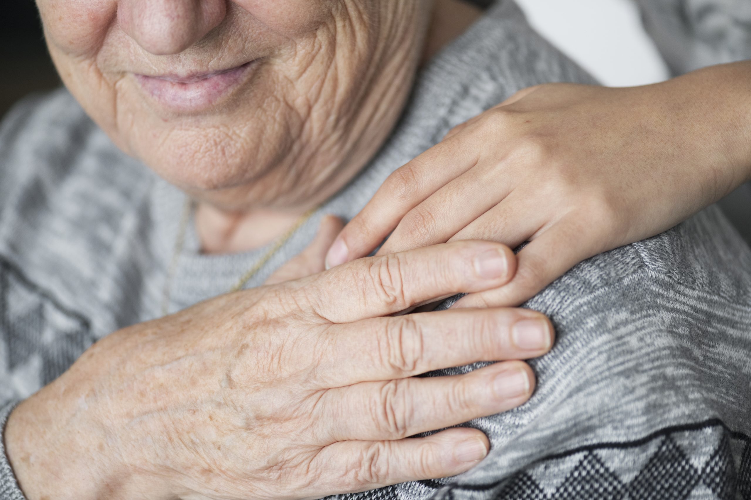 Closeup of a support hand by a home health and hospice care nurse
